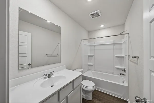 a bathroom with a sink mirror toilet and bathtub