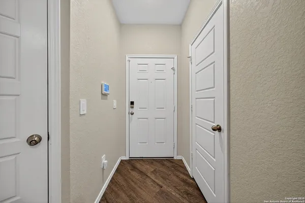 a view of a hallway with closet and wooden floor