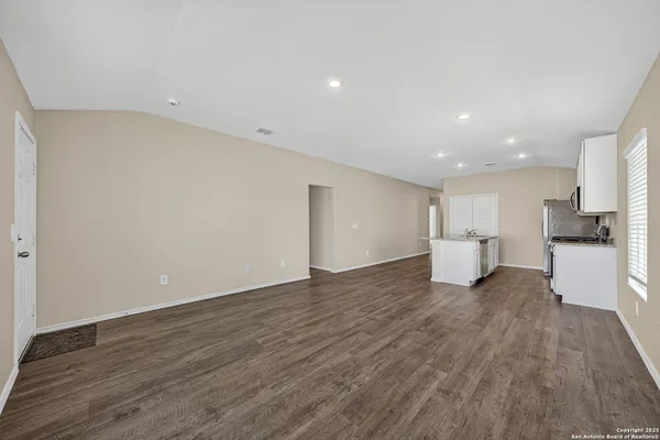 a view of a kitchen with a sink and a refrigerator