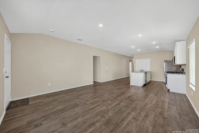 a view of a kitchen with a sink and a refrigerator