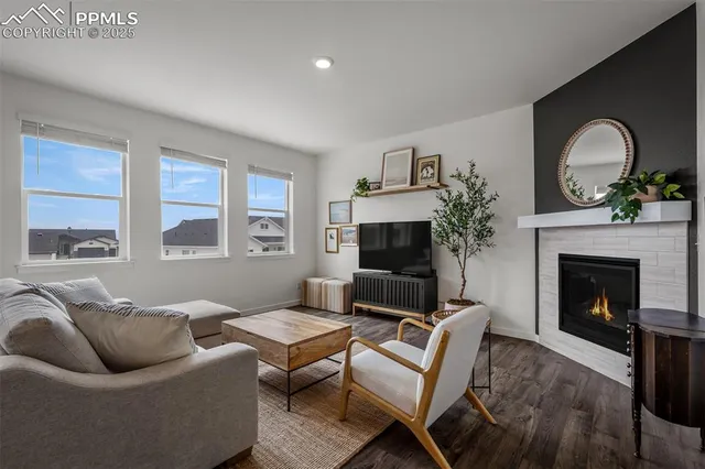 a living room with furniture a window and a fireplace