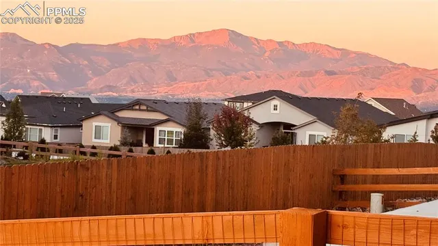 a view of a house with a mountain in the background