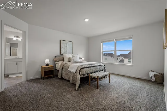 a spacious bedroom with a bed and a window
