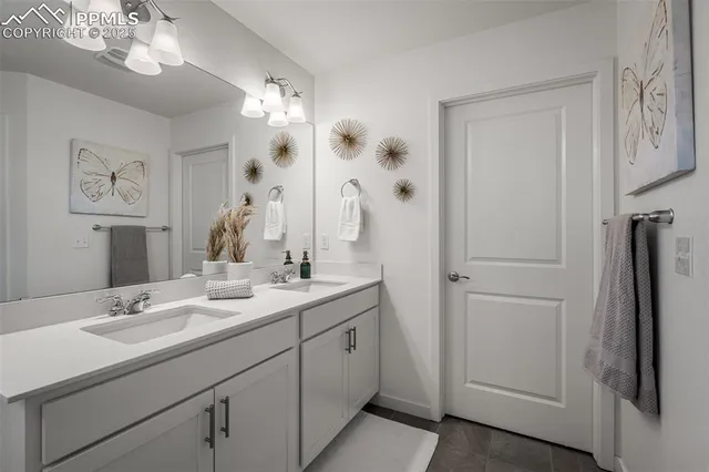 a bathroom with a double vanity sink and a mirror