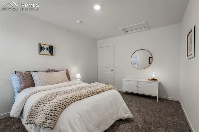 a bed room with a bed mirror and a window