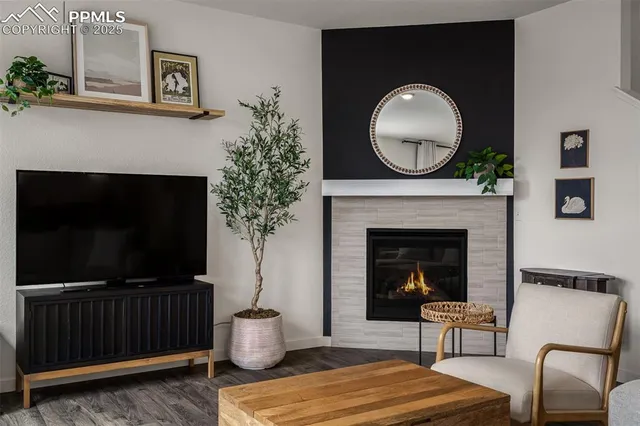 a living room with furniture a flat screen tv and a fireplace