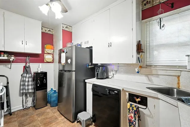 a kitchen with stainless steel appliances kitchen island granite countertop a sink and cabinets