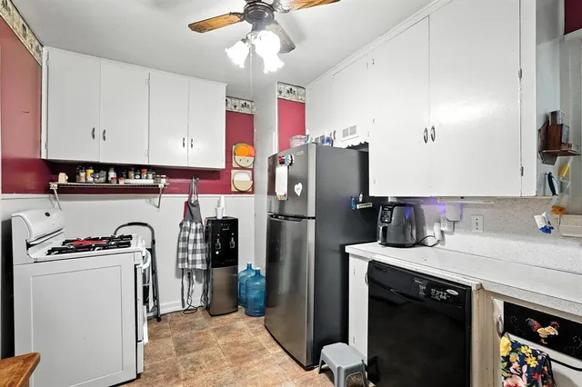 a kitchen with granite countertop a refrigerator and a sink