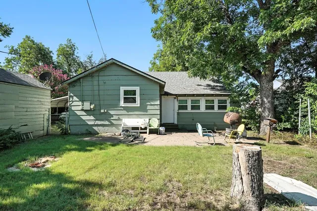 a backyard of a house with table and chairs