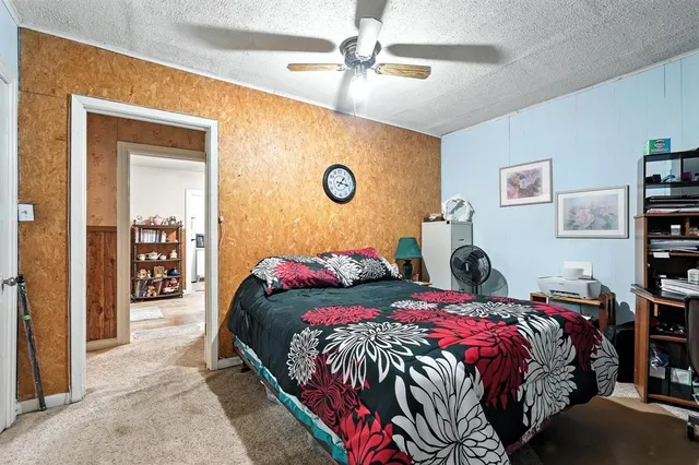 a bedroom that has a bed and a dresser in it