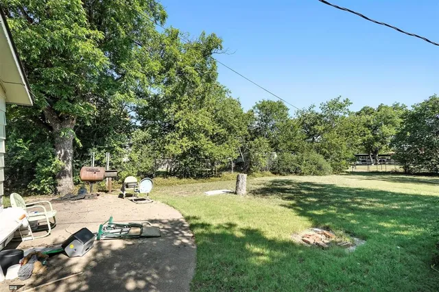 a backyard of a house with table and chairs