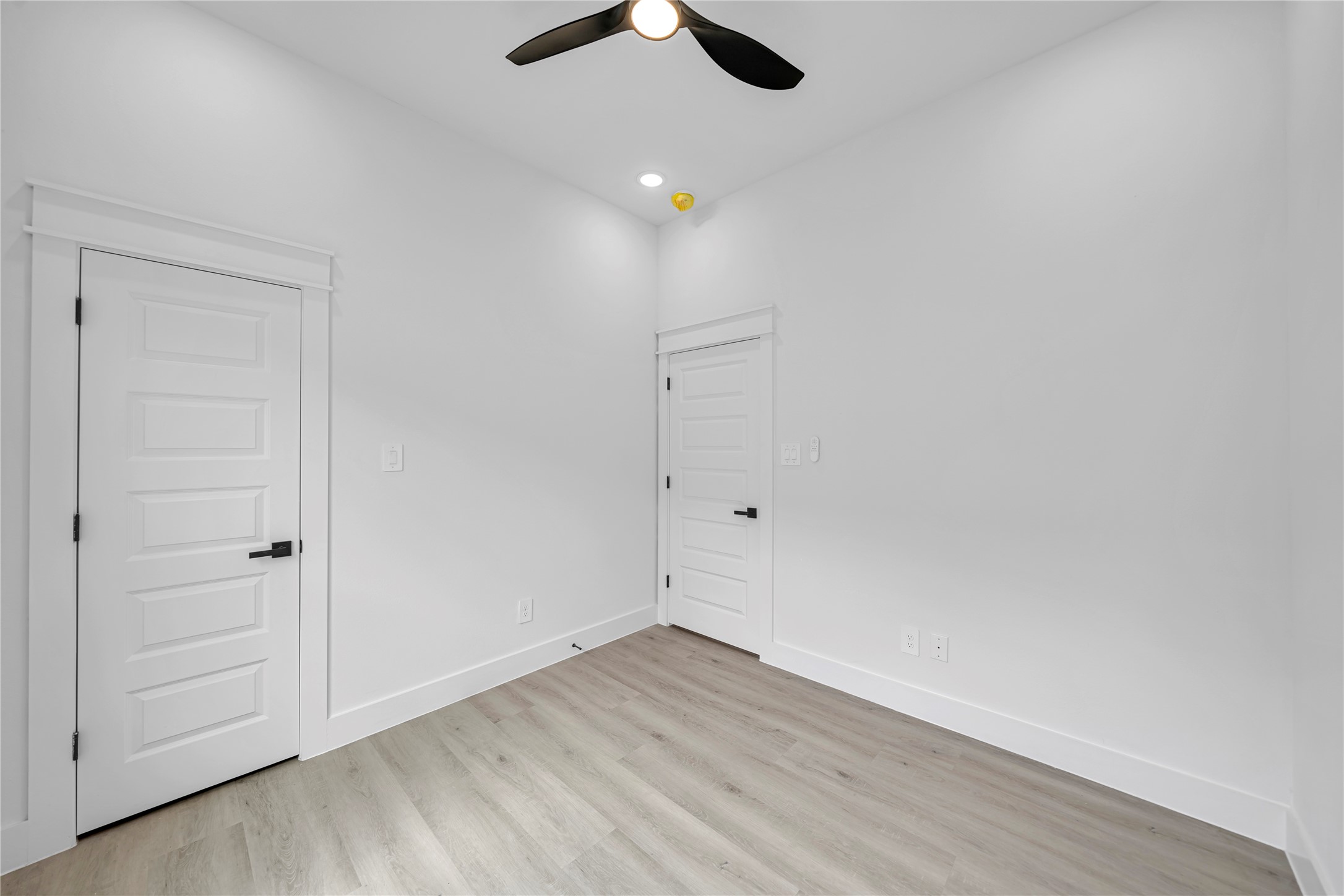 4834 Higgins Street, Unit B Houston, TX 77033 - Photo 19 of 34 wooden floor in an empty room with a ceiling fan