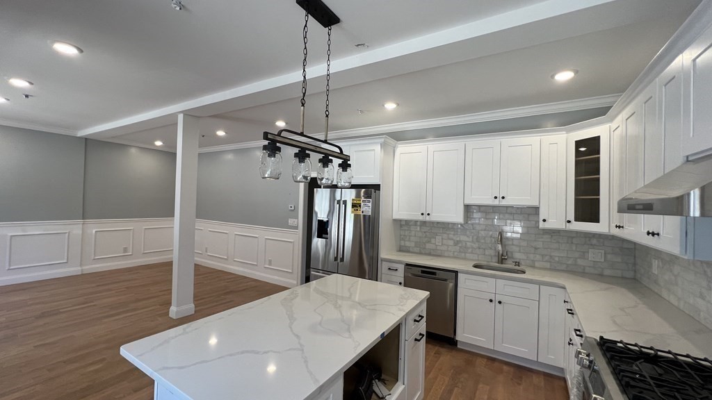 336 Cambridge Street, Unit A Burlington, MA 01803 - Photo 13 of 17 a kitchen with counter top space cabinets and wooden floor