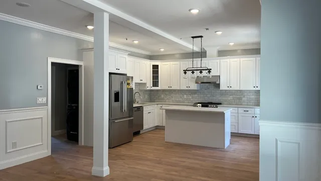 a kitchen with a refrigerator and a sink