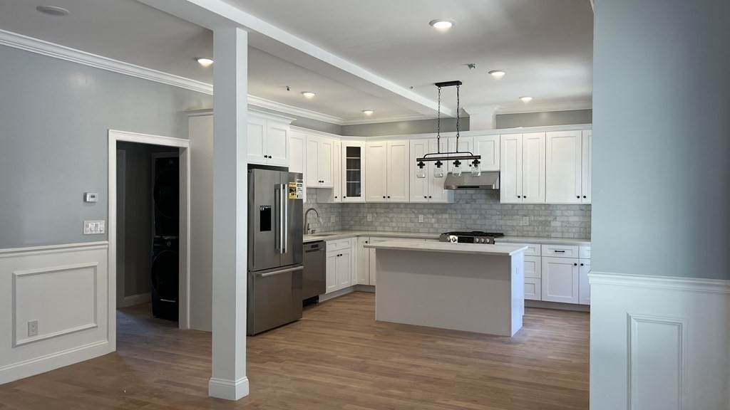336 Cambridge Street, Unit A Burlington, MA 01803 - Photo 14 of 17 a kitchen with a refrigerator and a sink