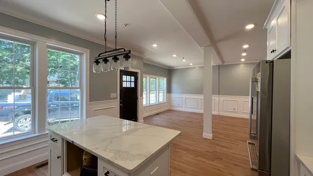 a view of a kitchen cabinets a table and chairs in a room