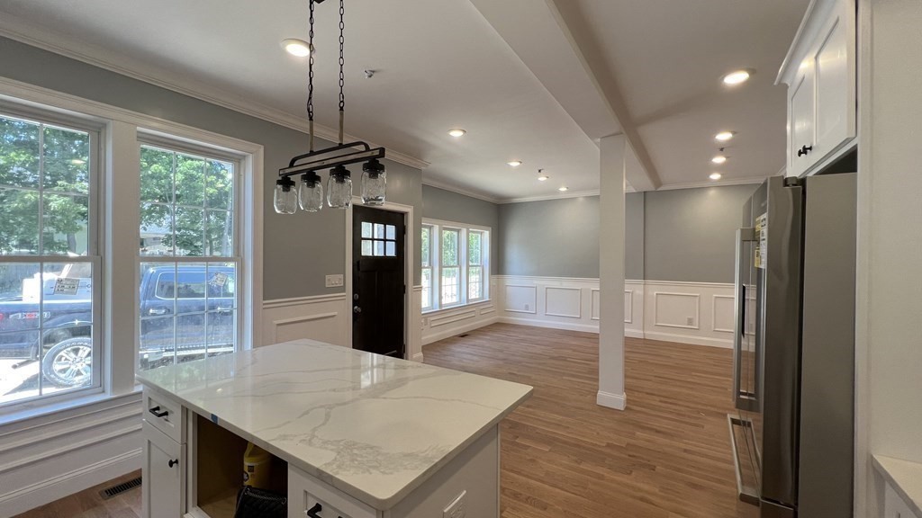 336 Cambridge Street, Unit A Burlington, MA 01803 - Photo 2 of 17 a view of a kitchen cabinets a table and chairs in a room