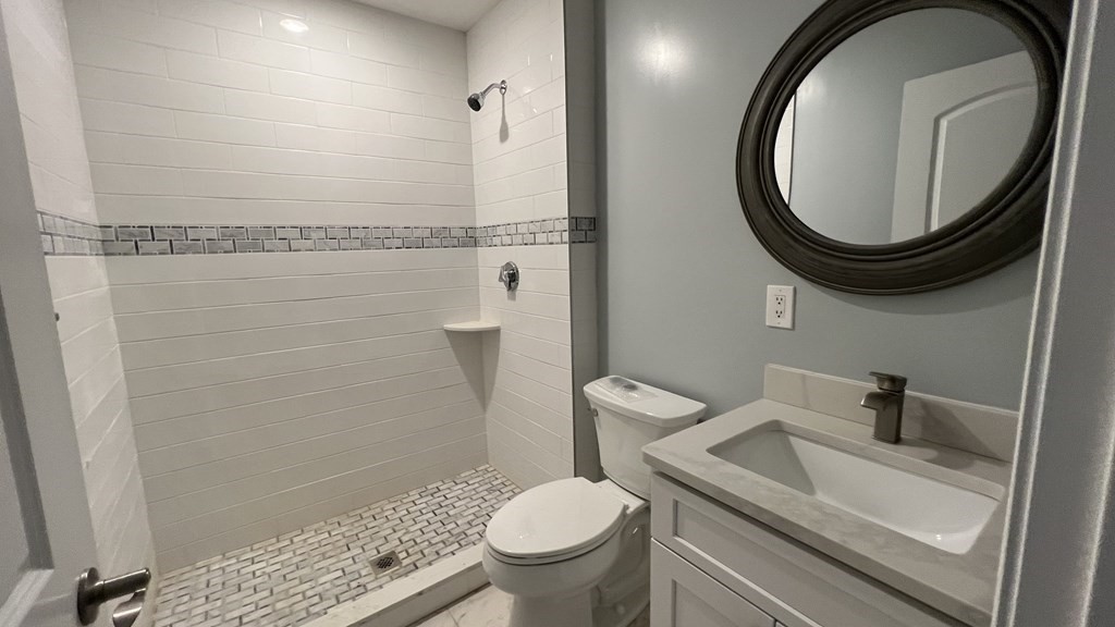 336 Cambridge Street, Unit A Burlington, MA 01803 - Photo 3 of 17 a bathroom with a toilet and a sink