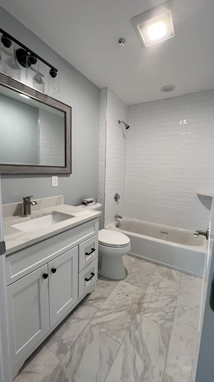 336 Cambridge Street, Unit A Burlington, MA 01803 - Photo 8 of 17 a bathroom with a double vanity sink and mirror with toilet