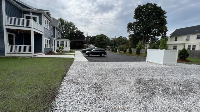 a view of a house with a yard and garage