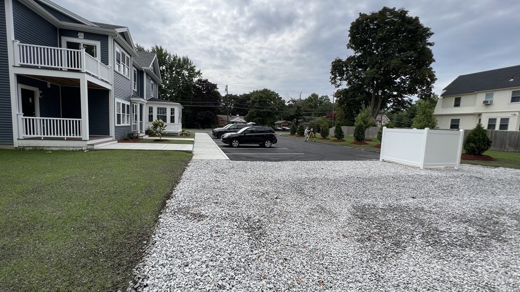 336 Cambridge Street, Unit A Burlington, MA 01803 - Photo 10 of 17 a view of a house with a yard and garage