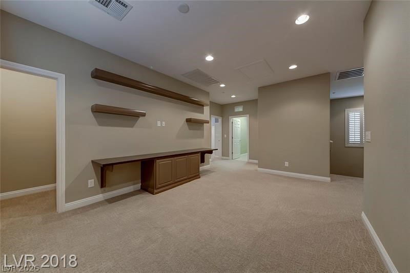 3144 Whitfeild Avenue Henderson, NV 89044 - Photo 16 of 55 An inviting family room, ready for entertainment, boasts recessed lighting and plush carpeted flooring.