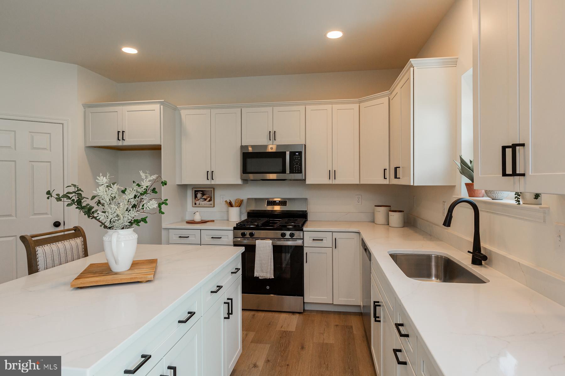 10 Ridgewood Road Quarryville, PA 17566 - Photo 17 of 48 a kitchen with white cabinets and appliances