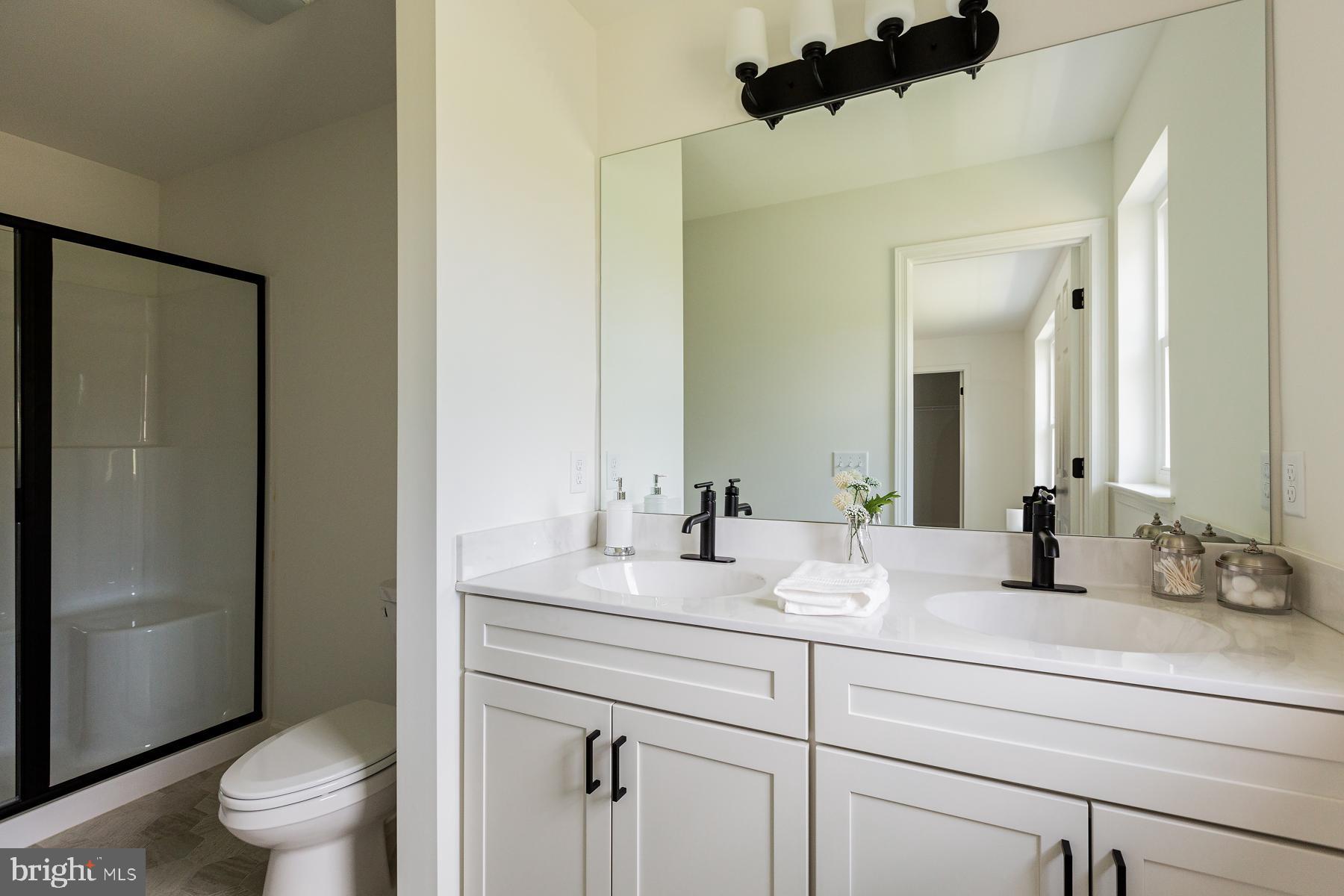 10 Ridgewood Road Quarryville, PA 17566 - Photo 29 of 48 a bathroom with a double vanity sink toilet and shower