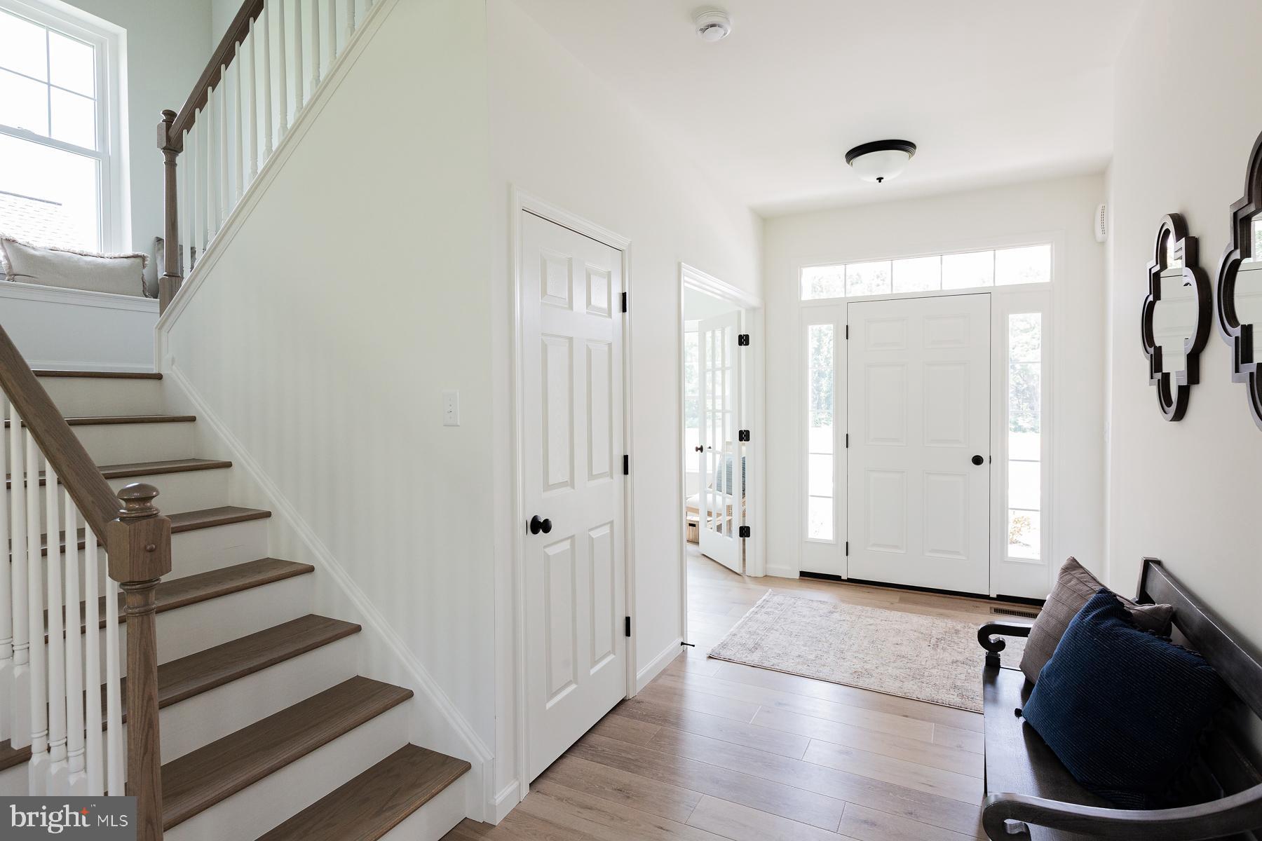10 Ridgewood Road Quarryville, PA 17566 - Photo 3 of 48 a view of a hallway with wooden floor and staircase