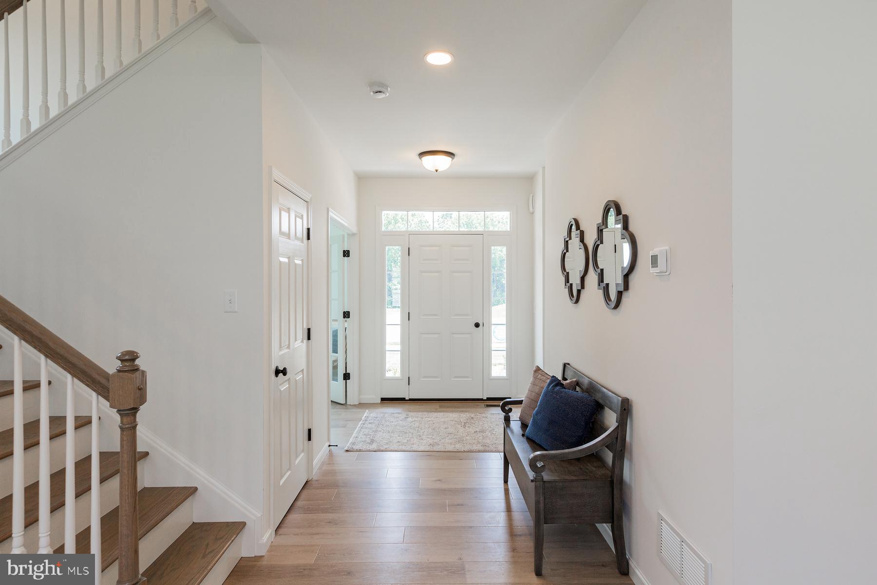 10 Ridgewood Road Quarryville, PA 17566 - Photo 8 of 48 a view of a hallway with entryway wooden floor and front door