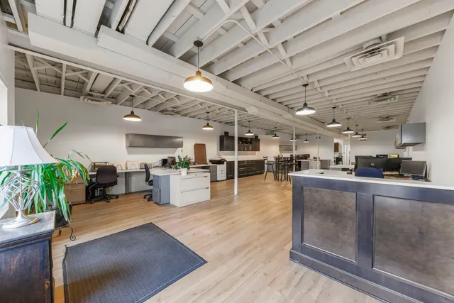 a large white kitchen with lots of counter space and windows