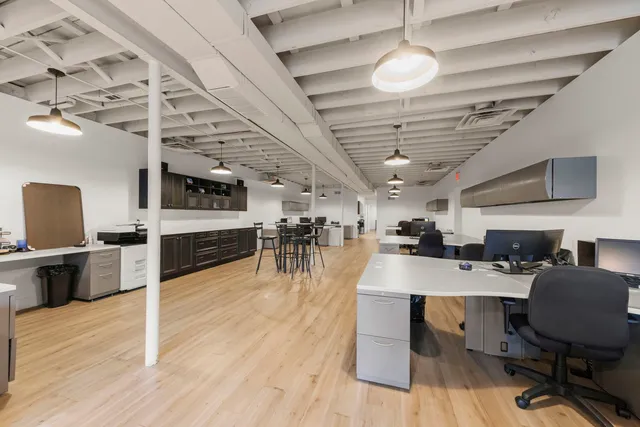 a room with stainless steel appliances lots of wooden furniture a chandelier