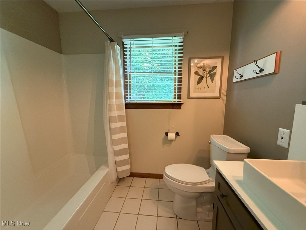 4901 Kings Creek Road Weirton, WV 26062 - Photo 10 of 28 Full bathroom featuring vanity, tile patterned flooring, and shower / bath combination with curtain