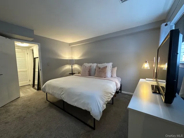 a bed room with a bed window and a night stand