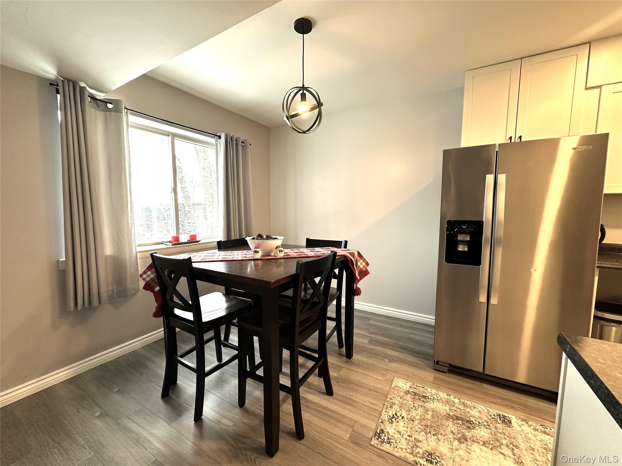 26 Cooper, Unit 510 Poughkeepsie, NY 12603 - Photo 6 of 28 Dining area featuring baseboards and light wood-style floors