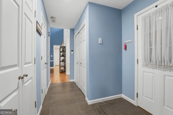 a view of a hallway with wooden floor and staircase
