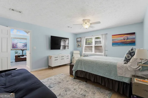 a bedroom with a bed and glass door