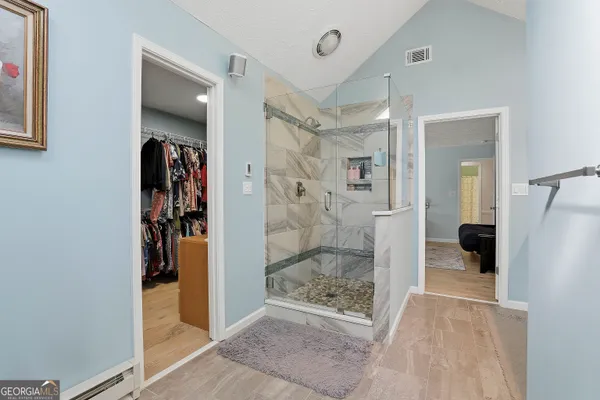 a view of a bathroom with a glass shower door