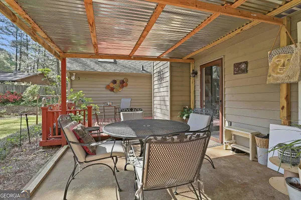 a dining room with furniture and wooden floor