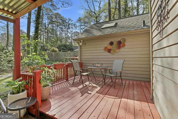 a view of deck with table and chairs and wooden floor