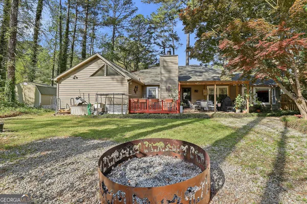 a view of a house with a backyard porch and sitting area