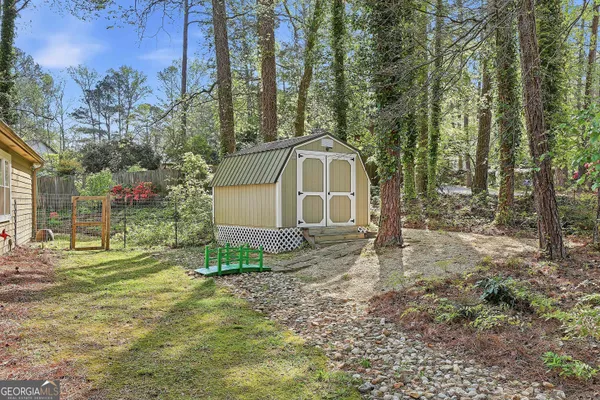 a view of a house with backyard and trees