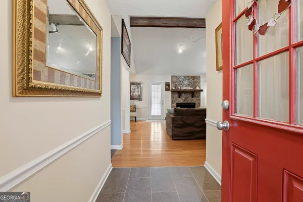 a view of a hallway view with wooden floor and staircase