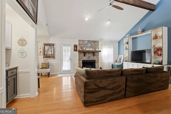 a living room with fireplace furniture and a flat screen tv