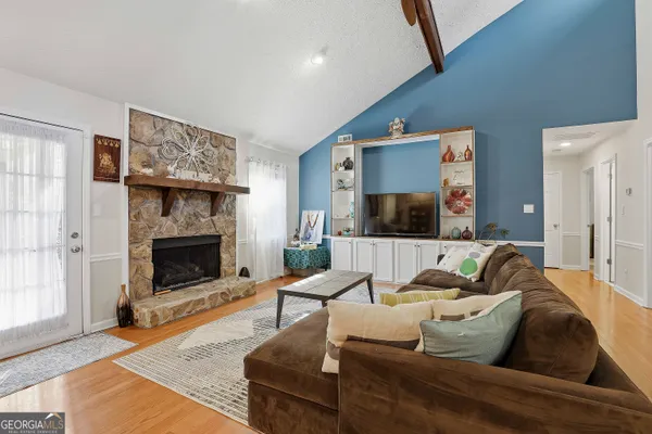 a living room with furniture and a fireplace