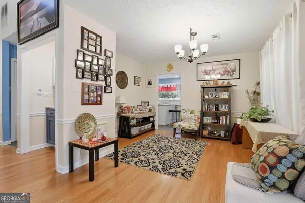 a living room with furniture and a chandelier