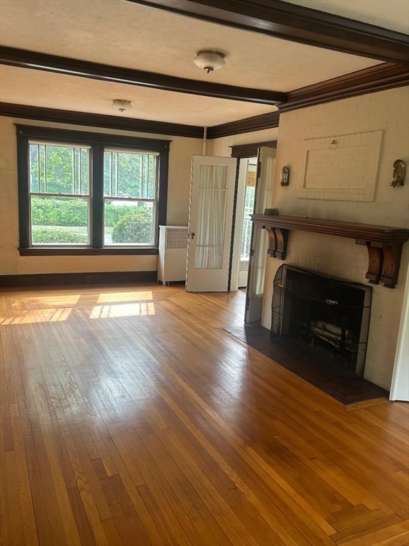 19 Wellesley Road Holyoke, MA 01040 - Photo 12 of 27 a view of a livingroom with wooden floor and a fireplace
