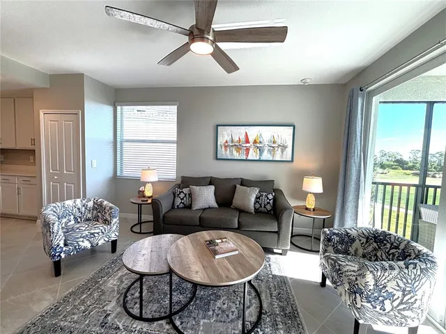 a living room with furniture and a large window
