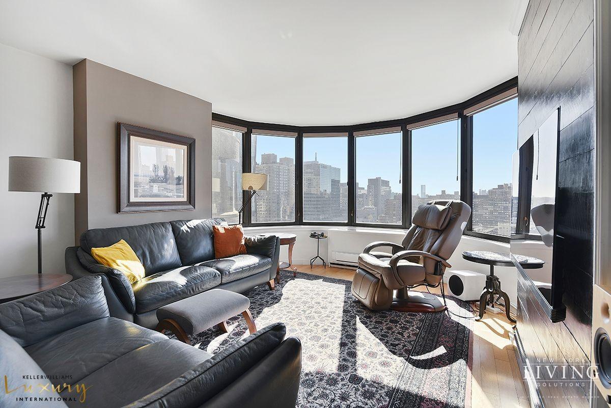 330 East 38th Street, Unit 24A Manhattan, NY 10016 - Photo 2 of 17 a living room with furniture and floor to ceiling windows