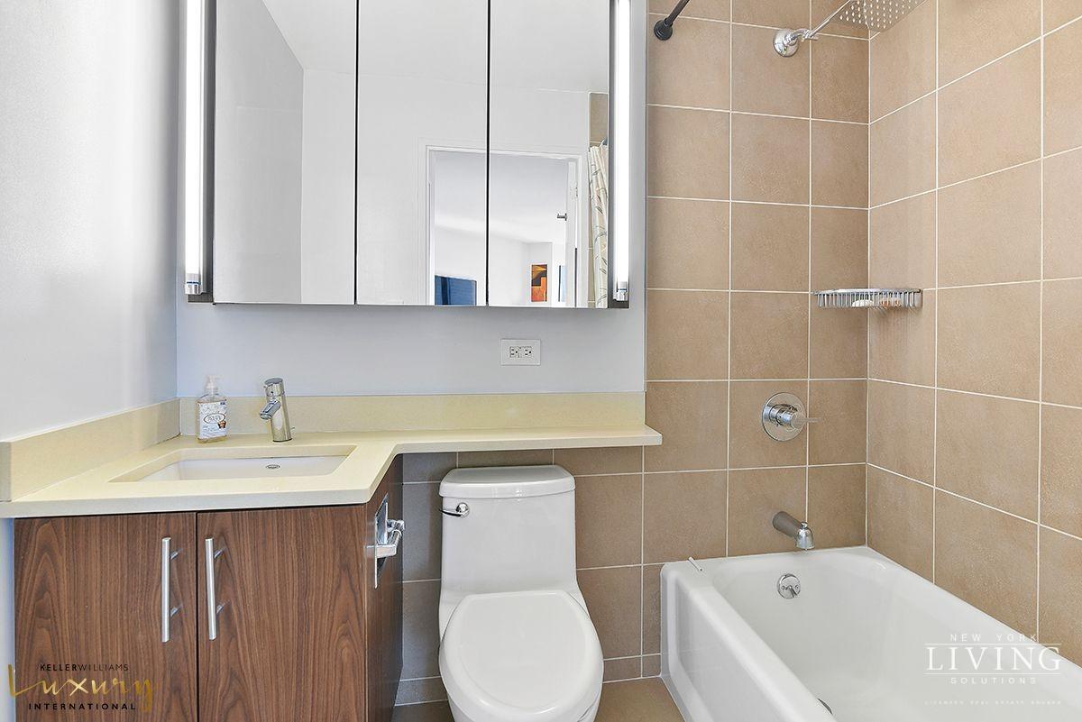 330 East 38th Street, Unit 24A Manhattan, NY 10016 - Photo 8 of 17 a bathroom with a sink toilet and shower
